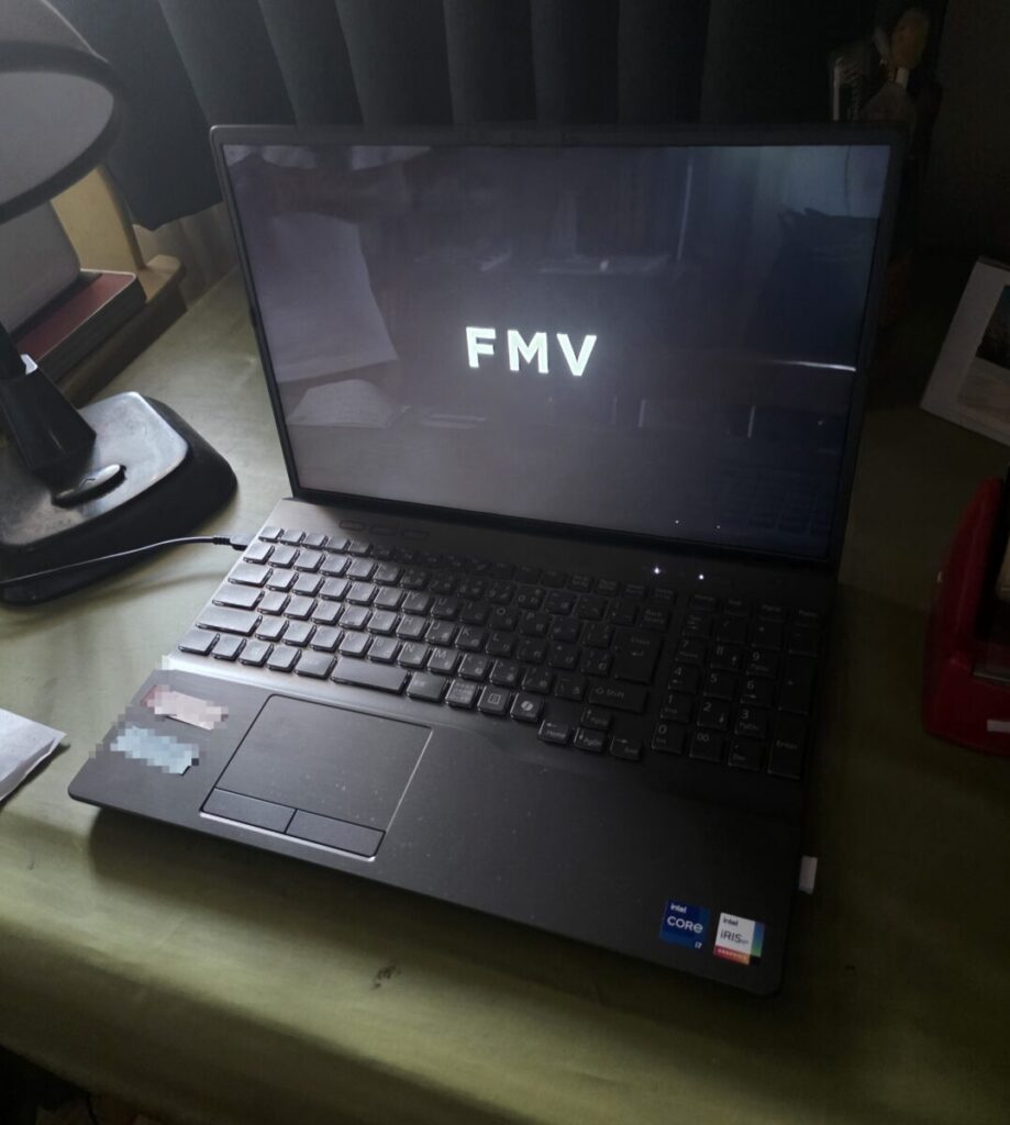 Fujitsu FMV laptop booting up with the FMV logo displayed on the screen.